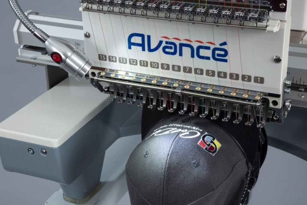 close up of a commercial embroidery machine with caps